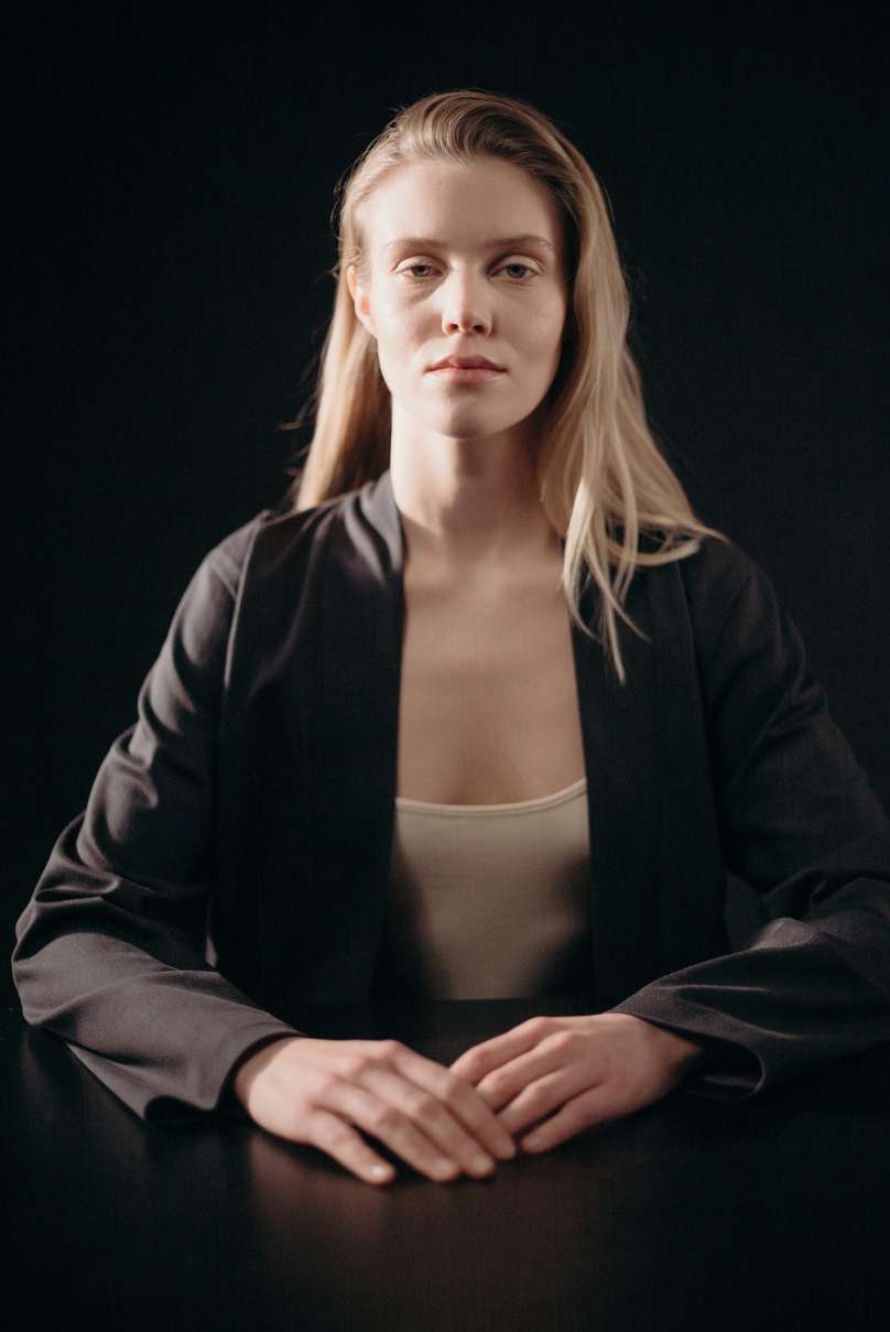 Woman in Black Blazer and White Top Sitting at Table